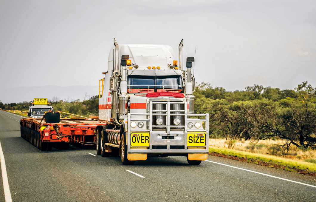 A truck and trailer waiting to be loaded with their oversized load.