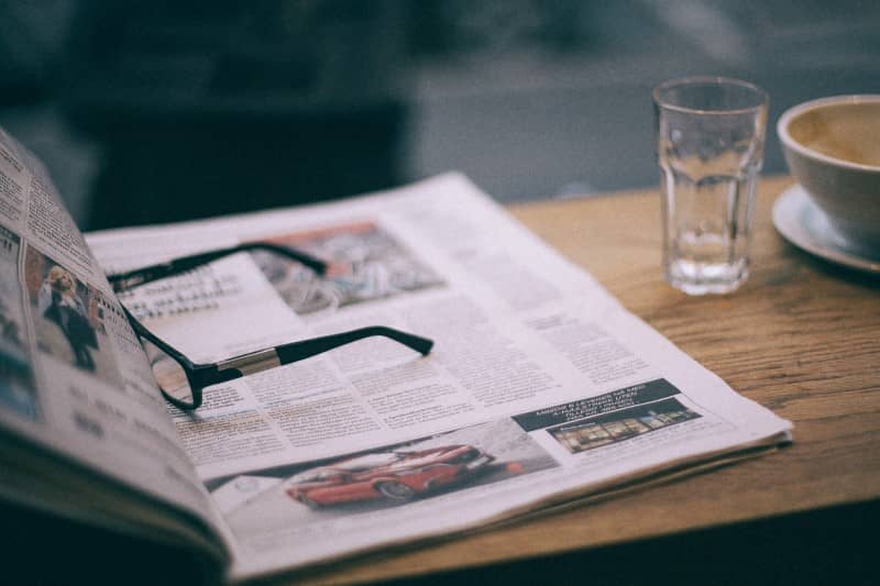 Open Newspaper With Glasses